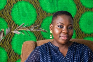 Ene Adesane(Soc Ent Founder of Ene Naturals) sitting on a chair